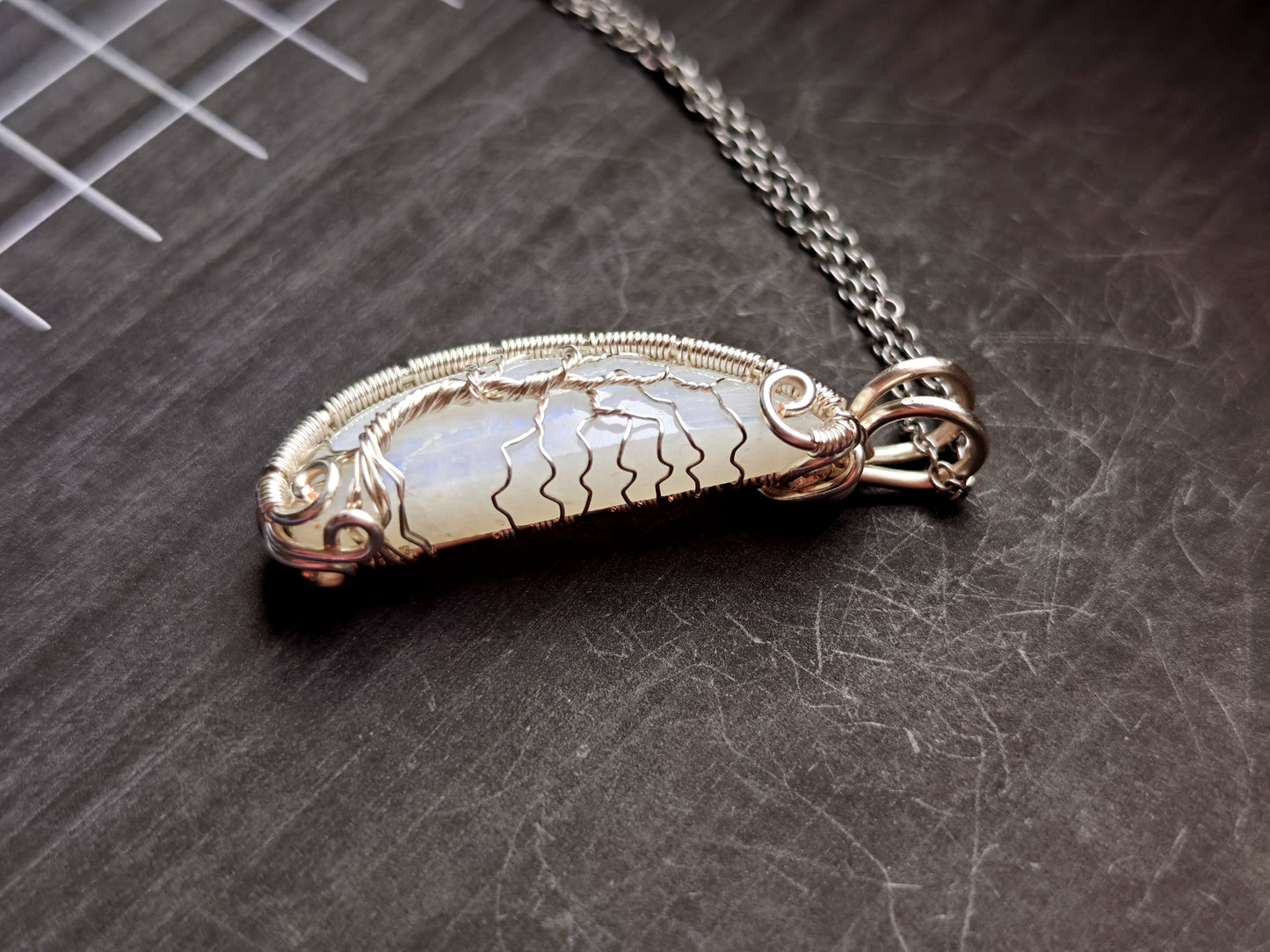 Tree pendant with a broken moonstone