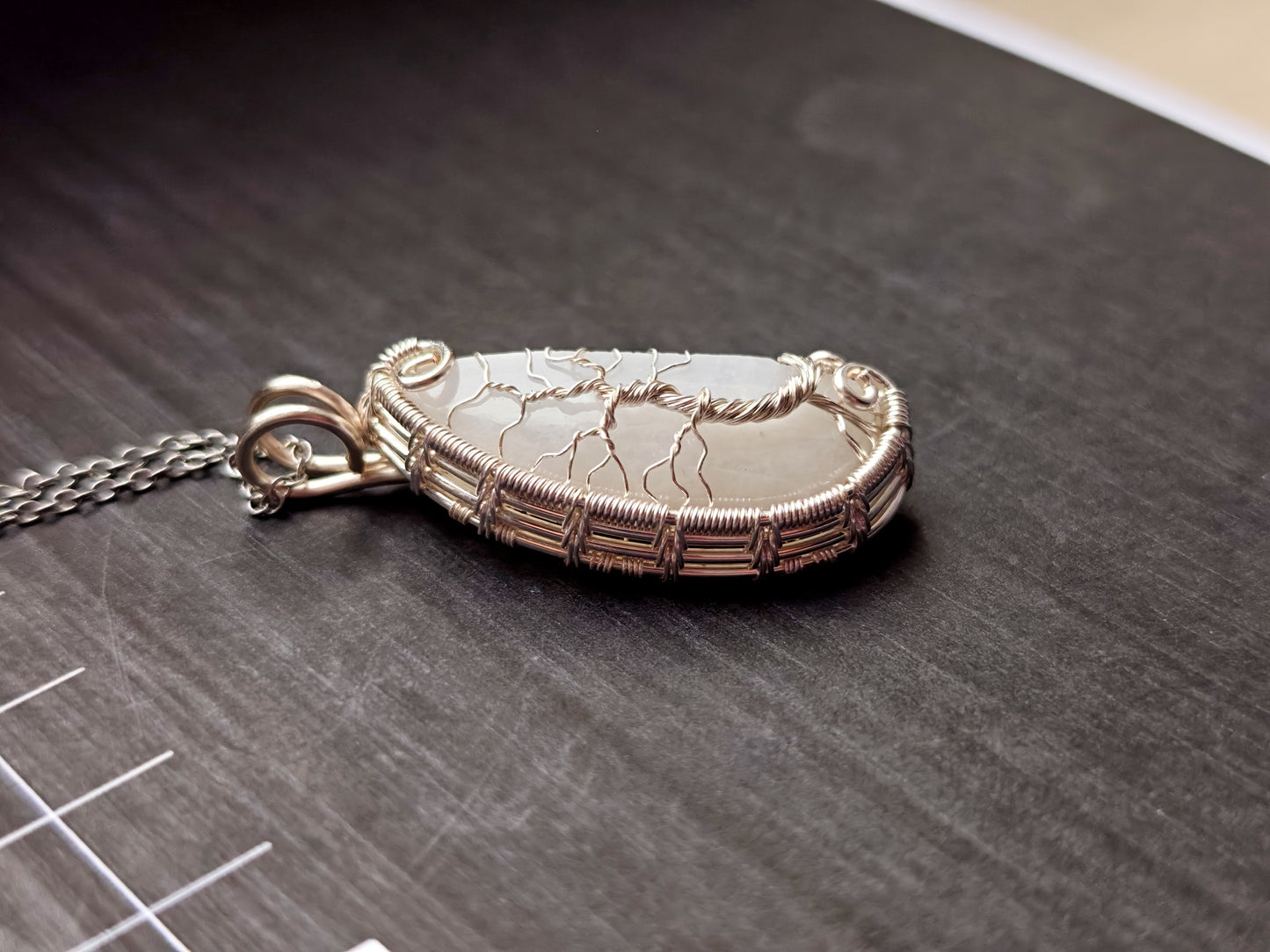 Tree pendant with a broken moonstone