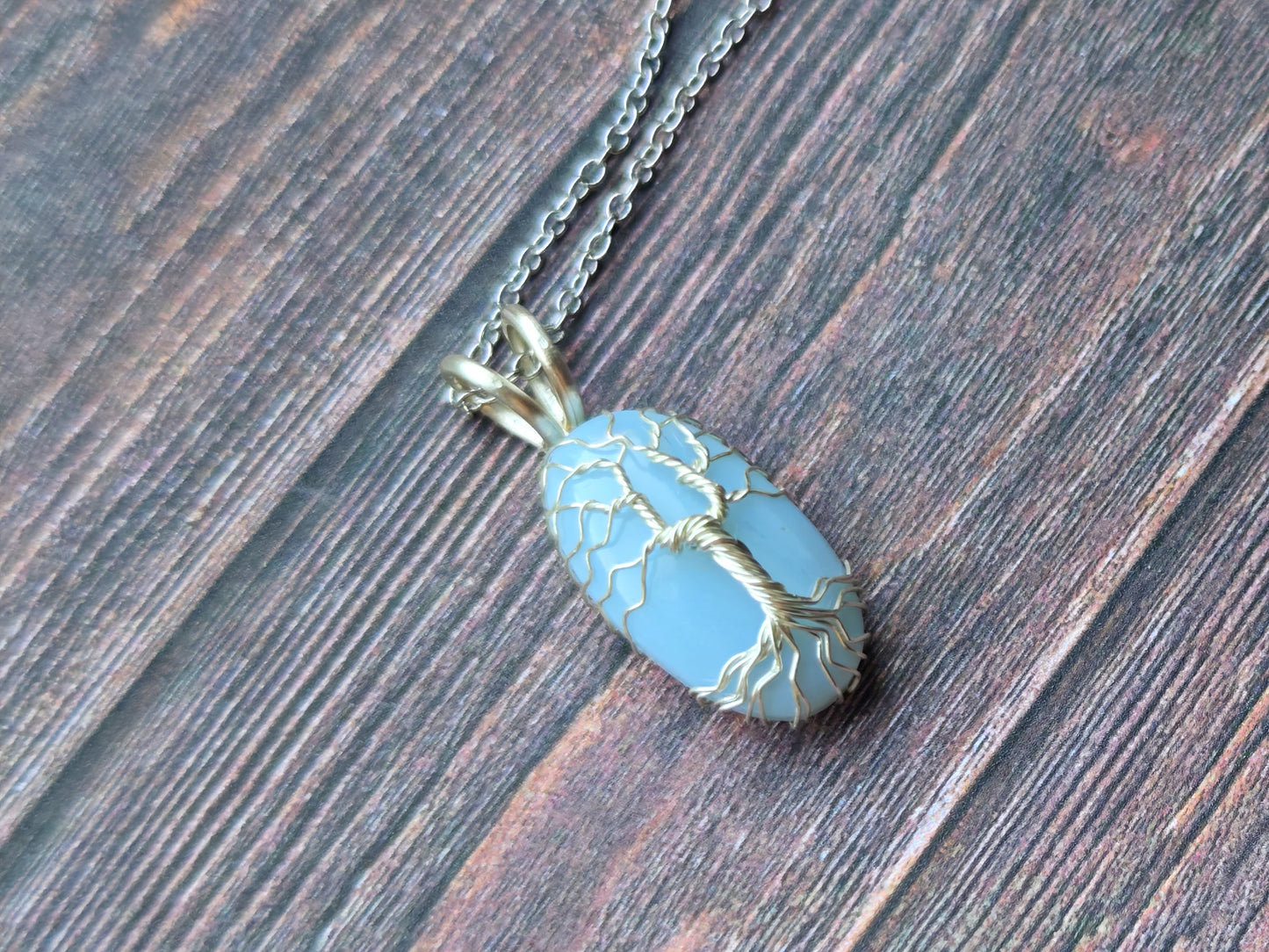 Tree pendant with a blue opal gemstone