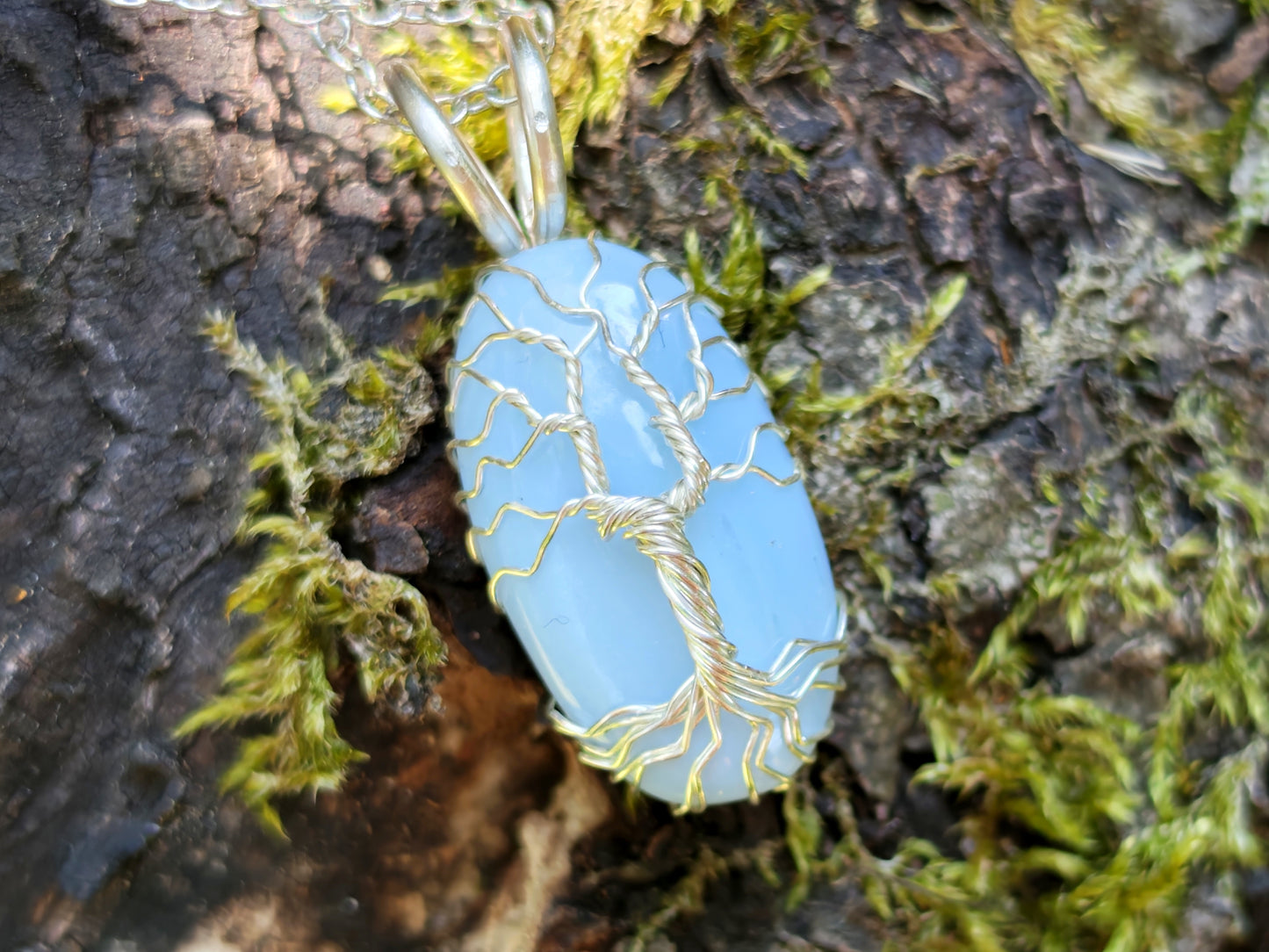 Tree pendant with a blue opal gemstone