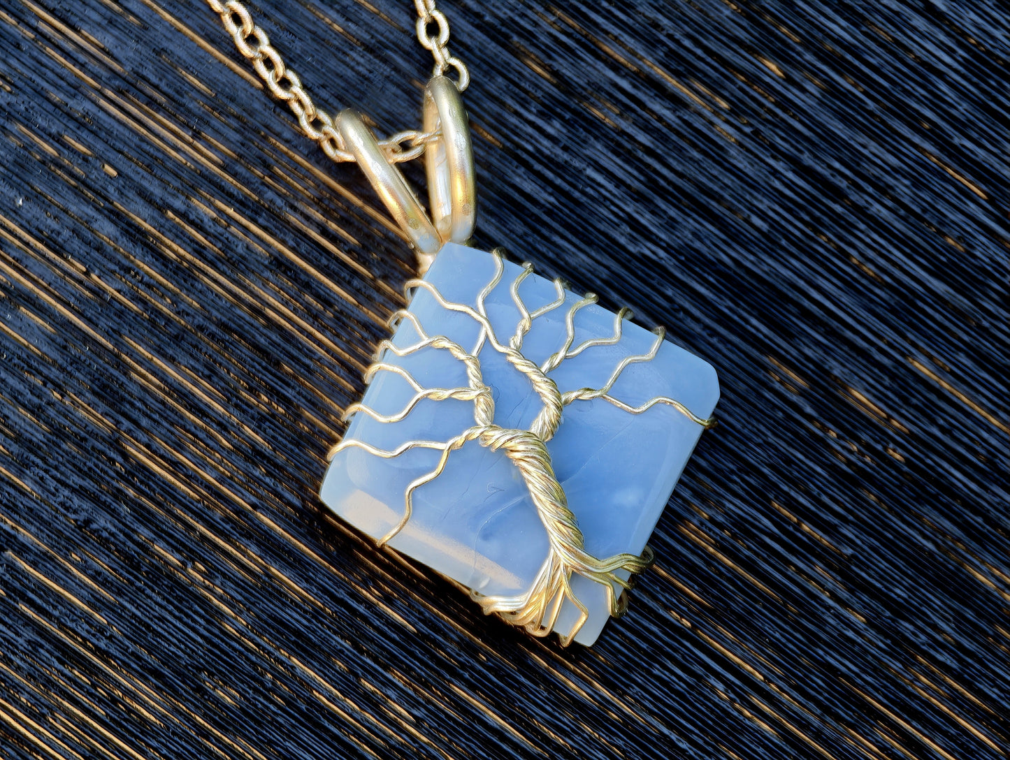 Tree pendant with a blue opal gemstone