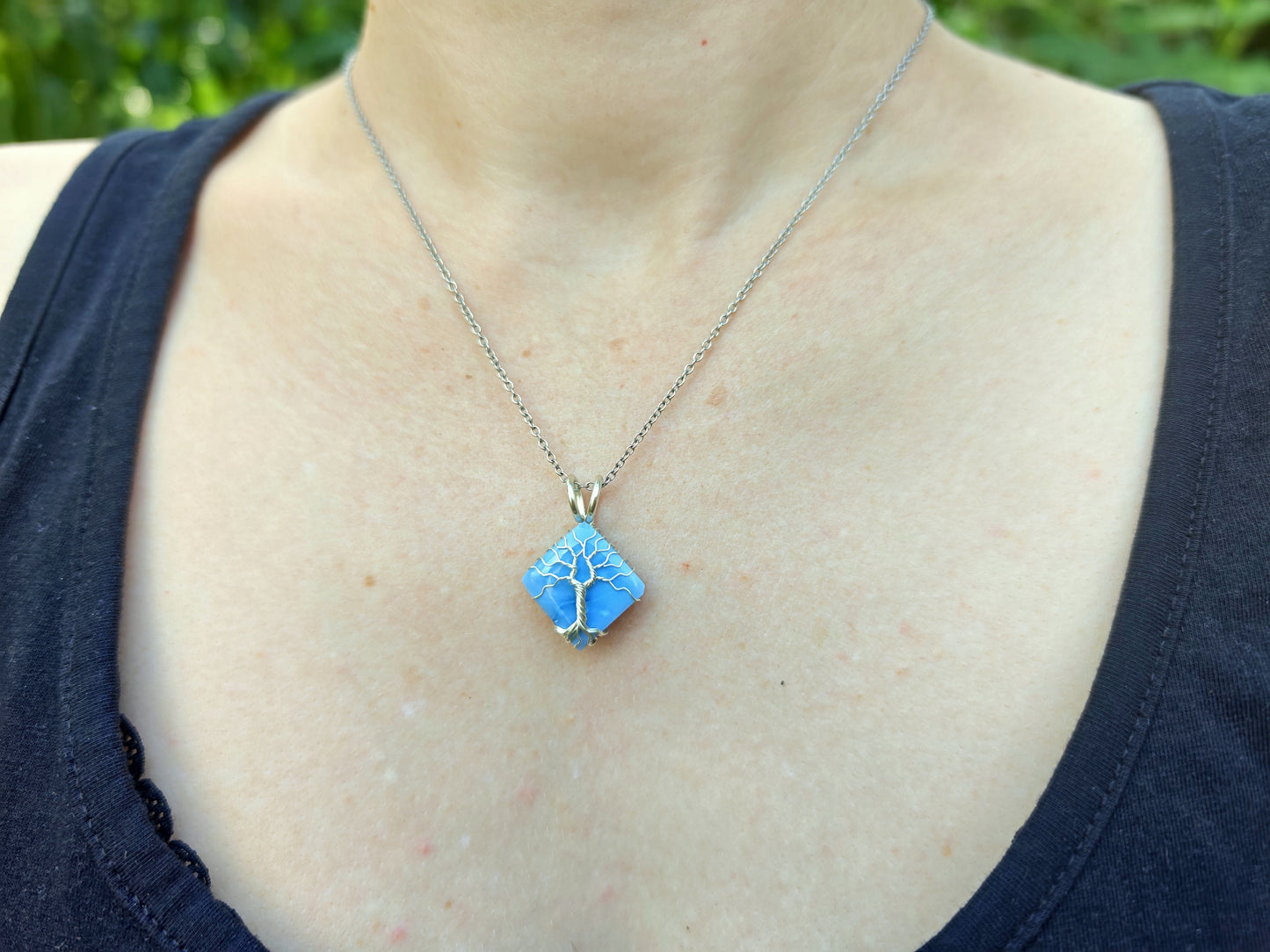 Tree pendant with a blue opal gemstone