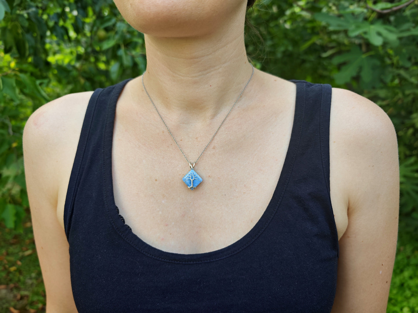 Tree pendant with a blue opal gemstone