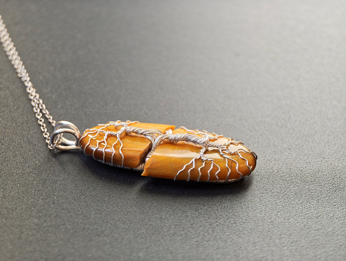 Tree pendant with a broken tiger's eye gemstone