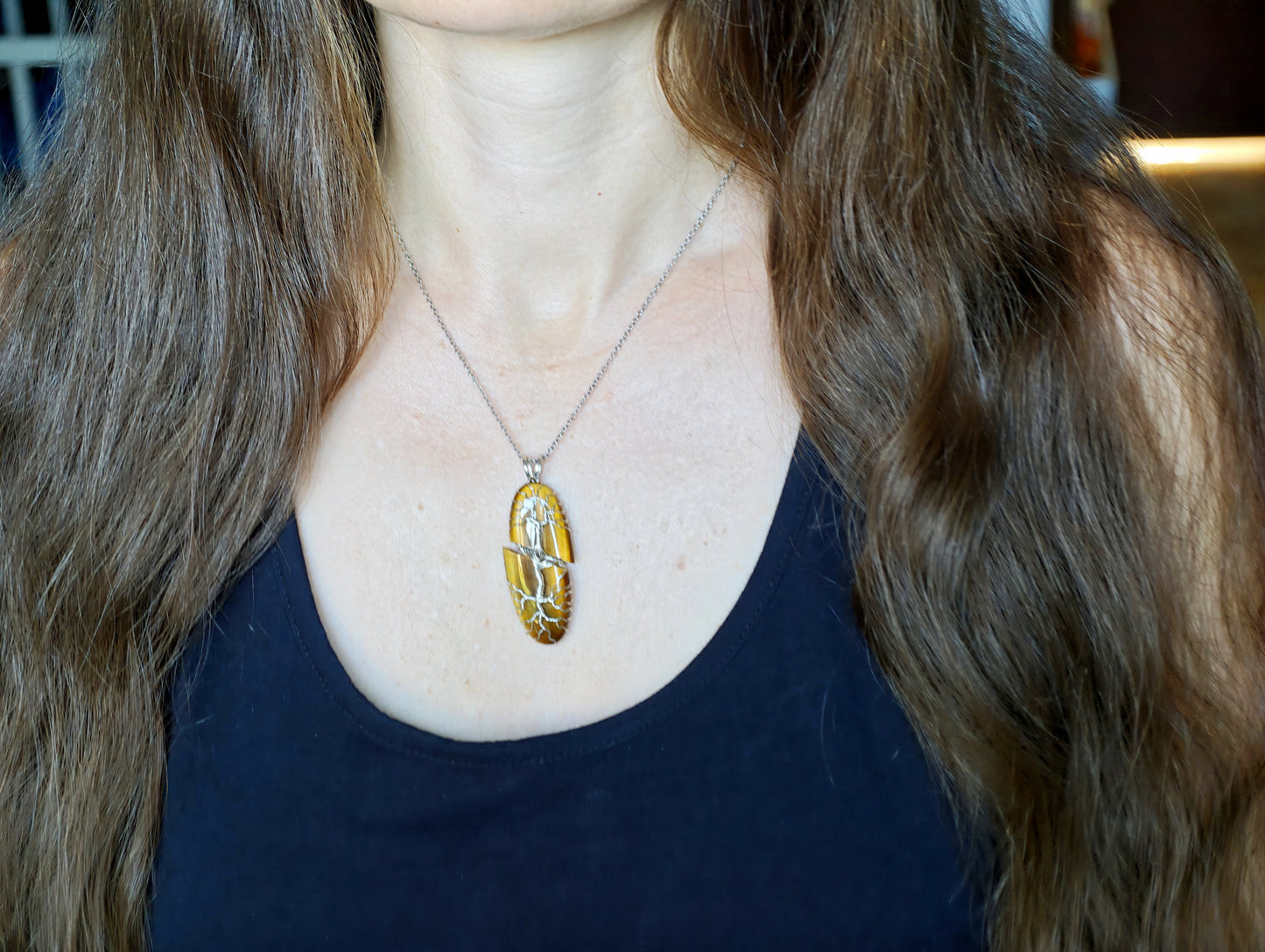 Tree pendant with a broken tiger's eye gemstone