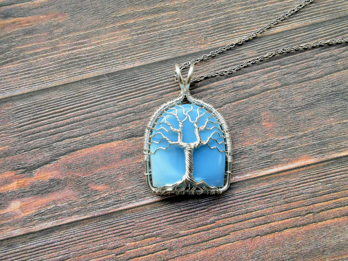 Tree pendant with a blue opal gemstone
