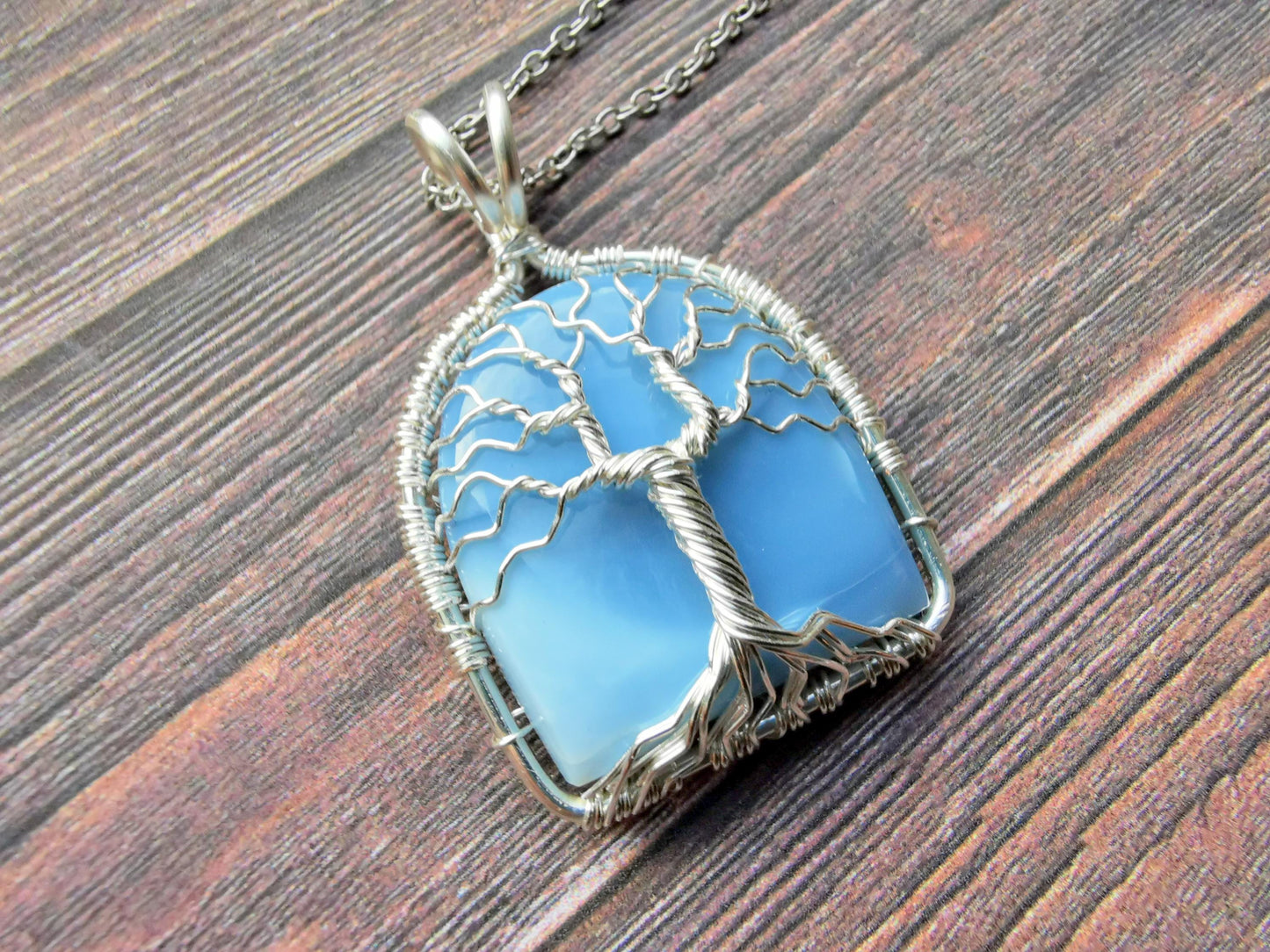 Tree pendant with a blue opal gemstone