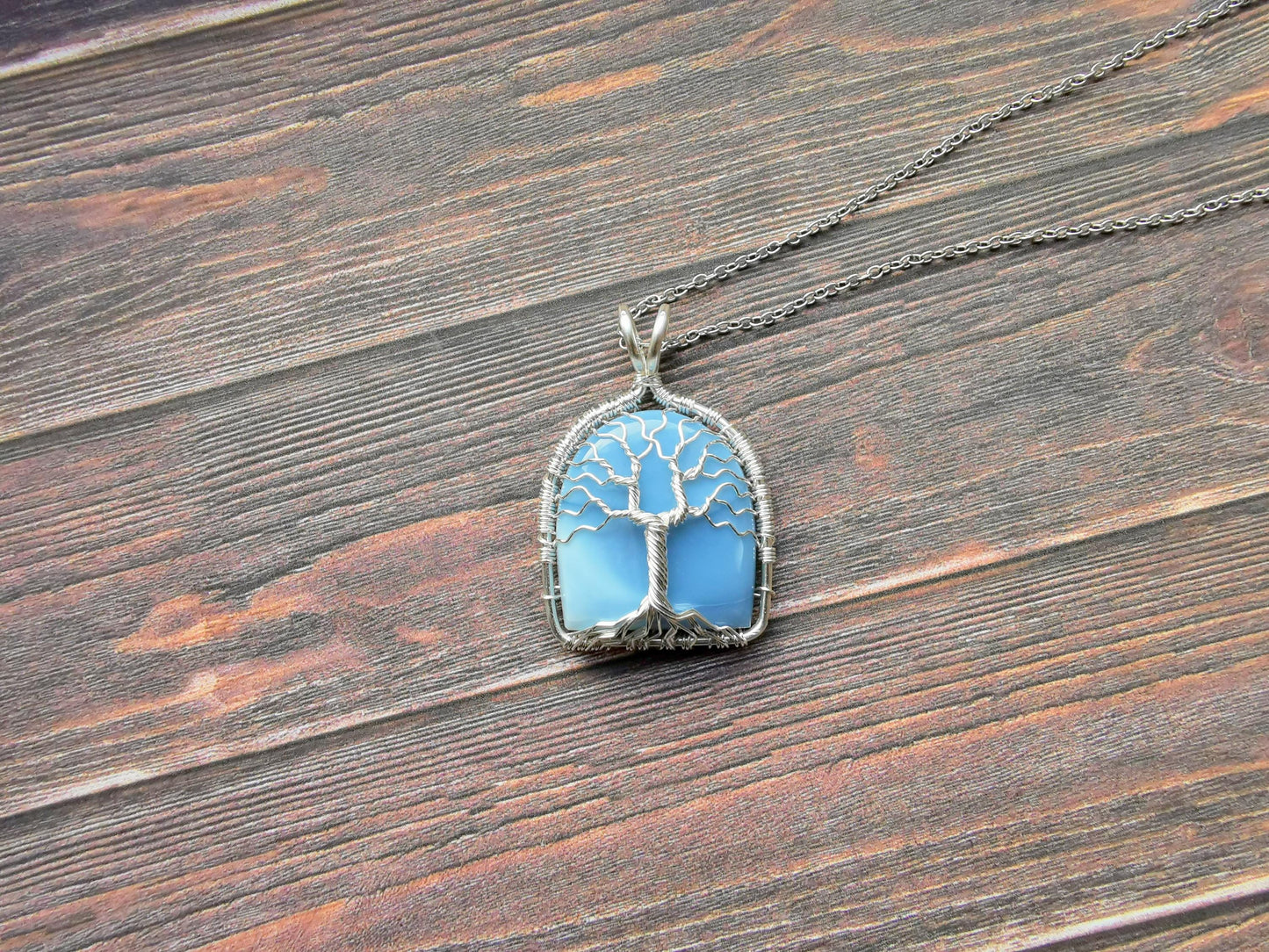 Tree pendant with a blue opal gemstone