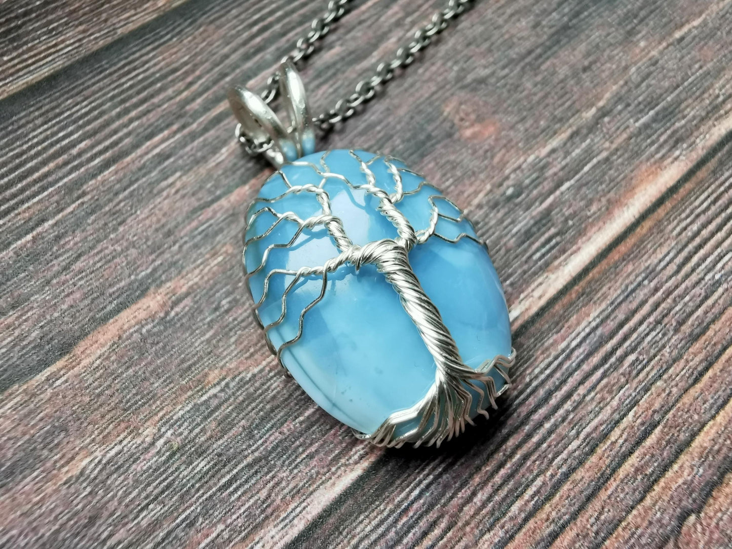 Tree pendant with a blue opal gemstone